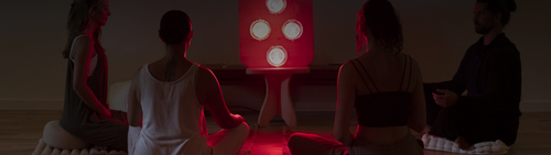 People sitting in meditation in front of Hearth Infrared Sauna Panel on Pedestal