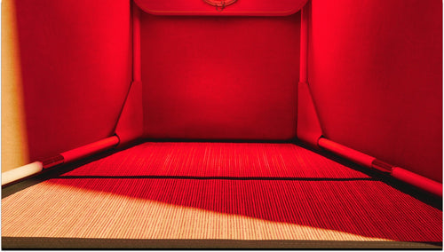 Lights on interior of FireLight Infrared Sauna showing bamboo grounding mat lining floor of sauna.