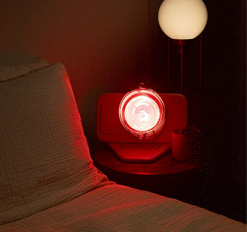 Glow Infrared Therapy Light on nightstand next to bed