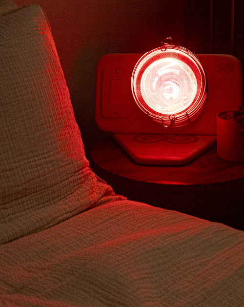 Glow Infrared Therapy Light on nightstand next to bed