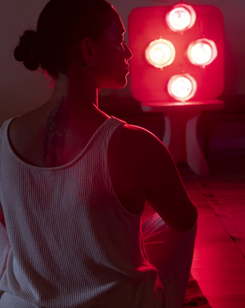 Woman sitting in front of Hearth Infrared Sauna Panel on Pedestal