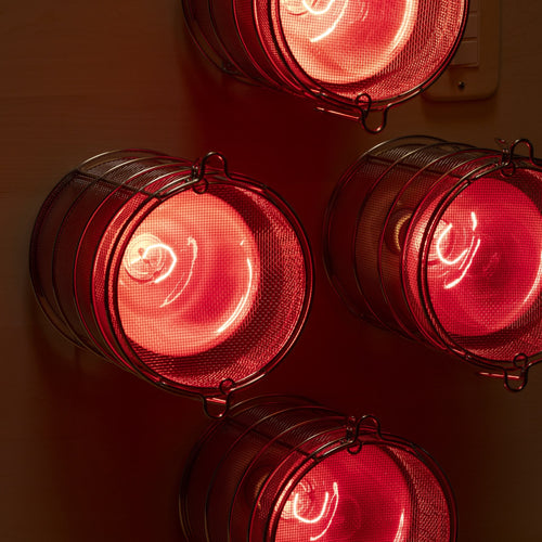 SaunaSpace Hearth Quartet Infrared Therapy Sauna Panel - close up of bulb guards with lights on