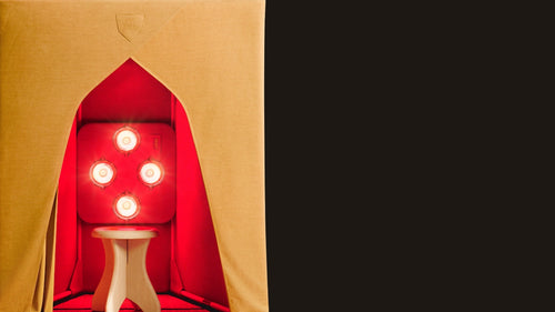 Close-up of front of FireLight Infrared Sauna - Turmeric Portable Enclosure with lights on and sauna stool inside.