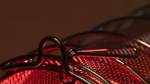 Close-up of stainless steel bulb guard with child-lock tab with FireLight bulb on