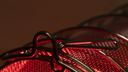 Close-up of stainless steel bulb guard with child-lock tab with FireLight bulb on