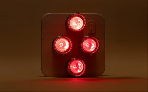 Hearth Quartet Infrared Therapy Sauna Panel with lights on against a dim beige background