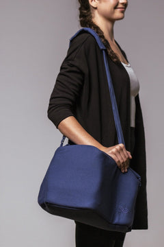 SaunaSpace Travel Soft Case for Glow Infrared Therapy Light - Indigo - woman holding case