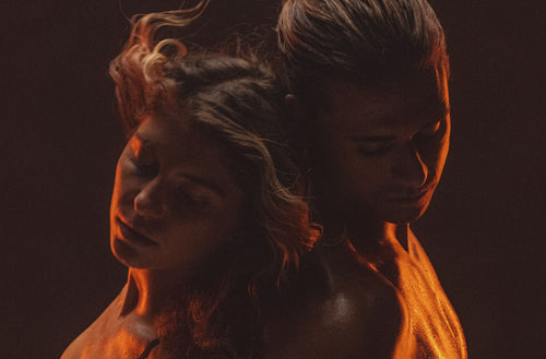 Two people embracing with a warm, FireLight® glow on a dark background