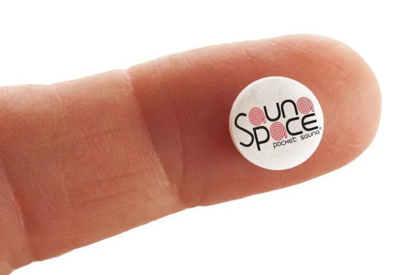 finger holding performance enhancing pill with SaunaSpace logo on pill