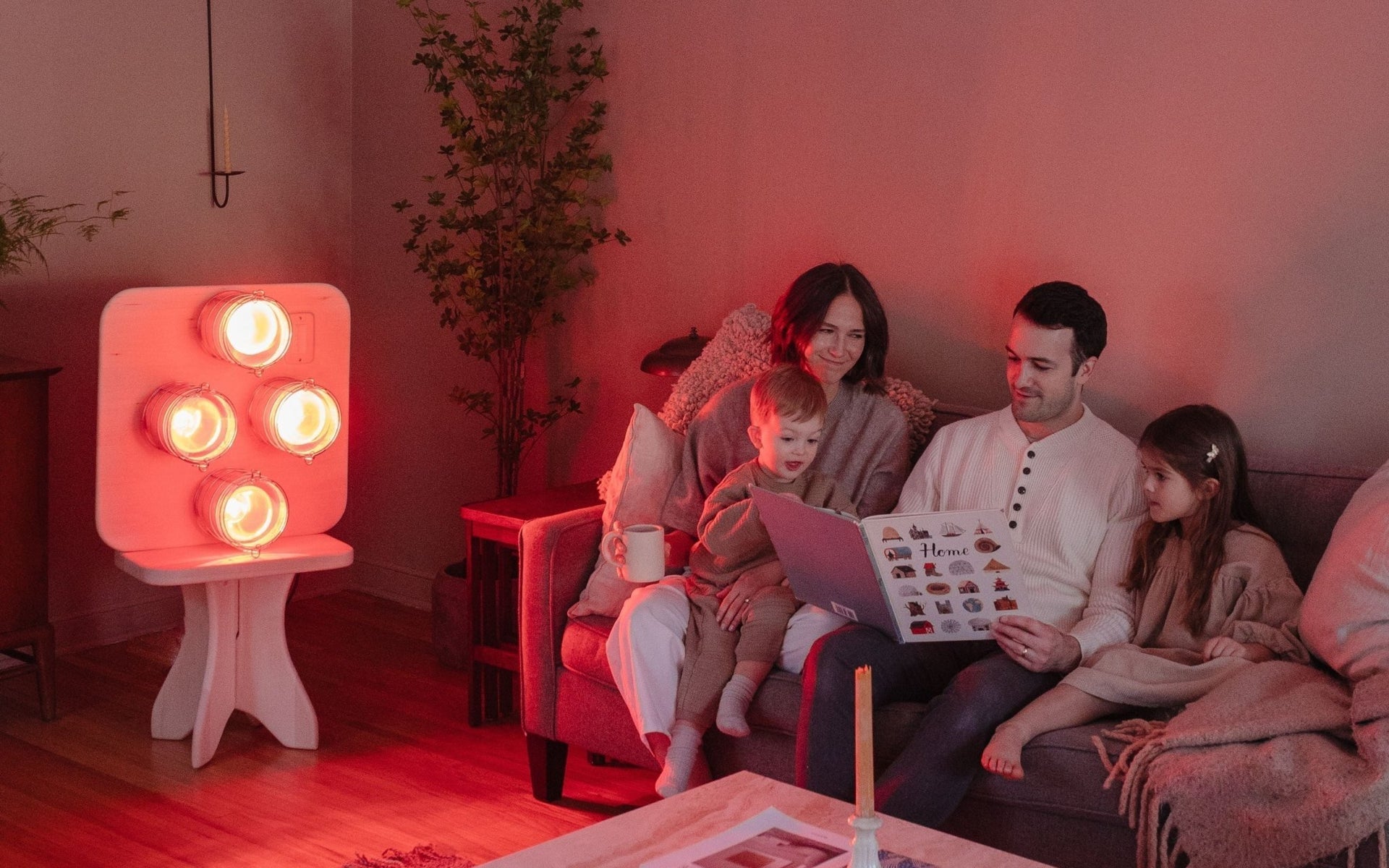 A modern living room bathed in soft red-gold infrared light, evoking the warmth and intimacy of a traditional fireplace, without smoke, firewood, or pollution.