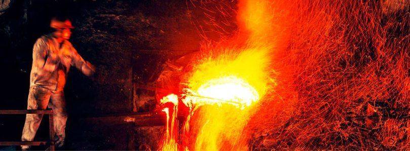 foundry worker next to molten metal