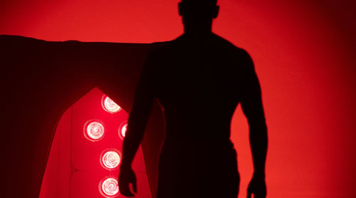silhouette of man walking toward FireLight® Infrared Sauna