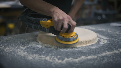 Worker sanding sauna stool top