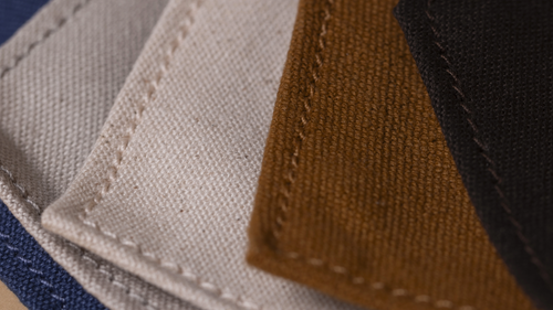 Close-up of color options for FireLight Infrared Sauna organic cotton cover, including Natural (undyed), Indigo, Dark Chocolate, Stone and Ayervedic-hand-dyed Turmeric