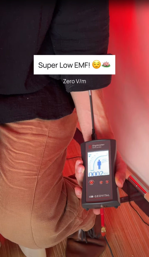 Person measuring zero Volts/Meter (V/m) of body voltage while sitting inside FireLight Infrared Sauna