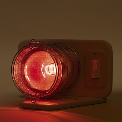 SaunaSpace Glow Infrared Therapy Light - on Basswood Glow Base in dark lighting