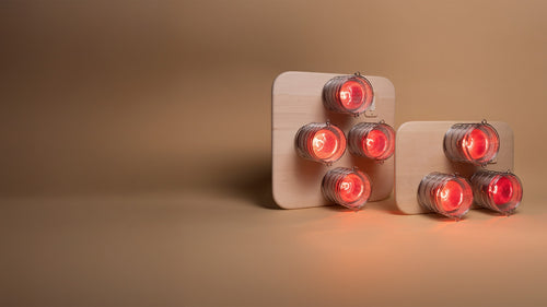 SaunaSpace Hearth Trio and Hearth Quartet Infrared Therapy Panels - standing up together with lights on against beige background
