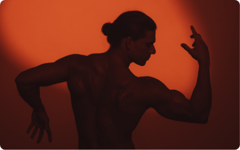 Muscular man with arms bent in dancing motion