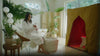 Woman in her home spa room drinking water and preparing to use FireLight Infrared Sauna and then using it and then taking a bath afterward.
