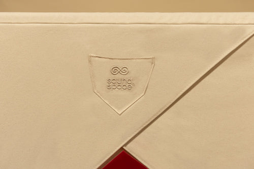 Close-up of entrance area of sauna cover showing the embroidered pocket of a FireLight Infrared Sauna - Natural