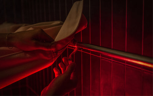 Close up of Infrared Shower Sauna Conversion Kit - Hands connecting Shower Curtain to Shower Rod
