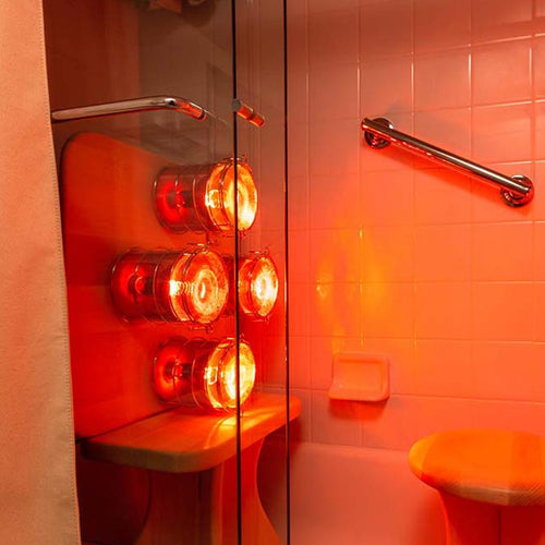 Shower Upgrade for Hearth Quartet Infrared Therapy Sauna Panel, wherein Hearth rests on Hearth Pedestal and Stool is opposite and Shower Curtain and Curtain rods enclose the top and front of full bath area.